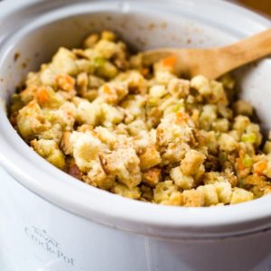 slow cooker stuffing with wooden spoon