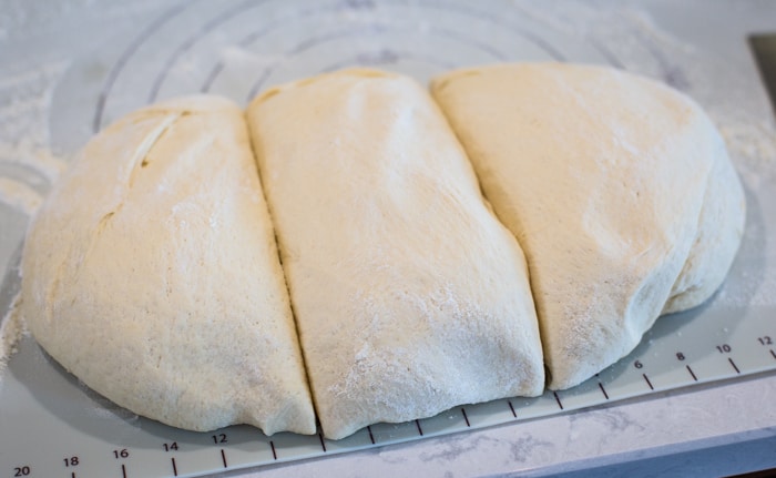 dough divided into three loaves