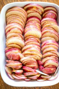 baking dish filled with sliced potatoes