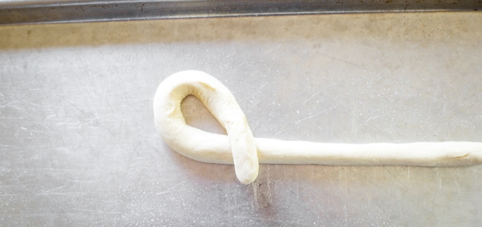 loop of dough rope to form pretzels