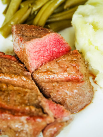 venison marinated steaks on plate