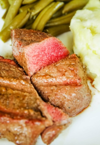 venison marinated steaks on plate