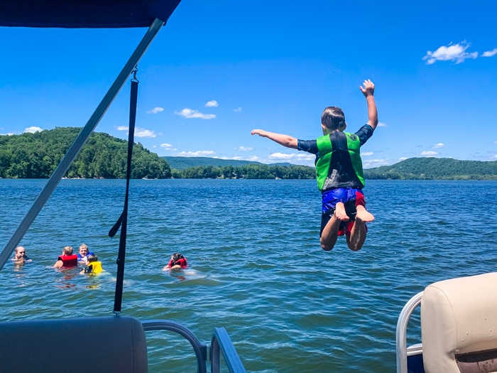 boy jumping off boat
