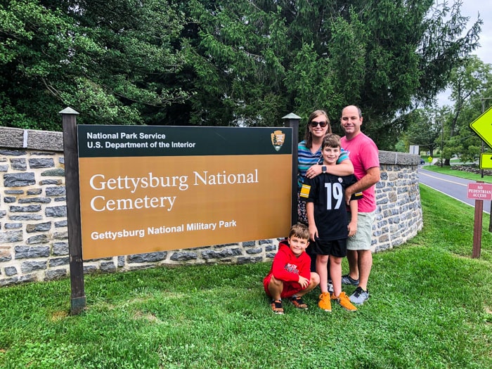 family in front of sign for Gettysburg sign