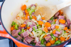stockpot full of ham and sauteed vegetables