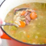 pot of ham and bean soup with ladle