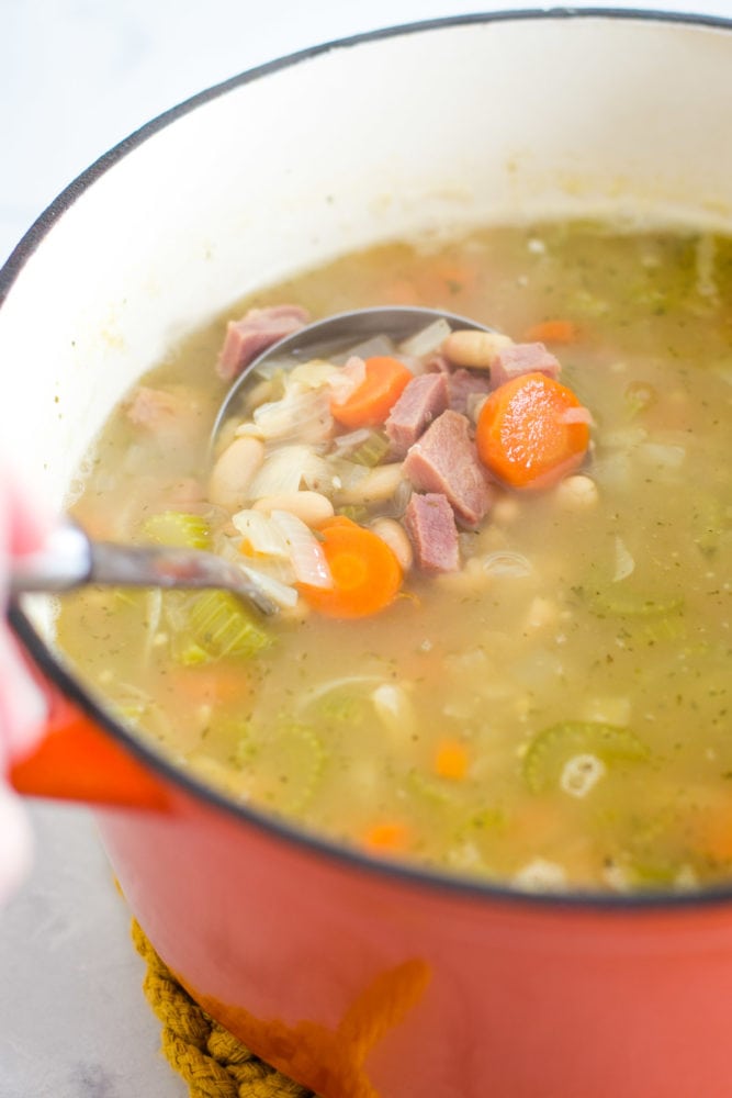 pot of ham and bean soup with ladle