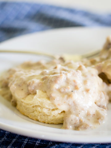 sausage biscuits and gravy on plate with fork