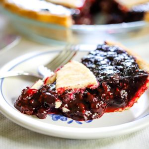 slice of mixed berry pie made with frozen berries on plate
