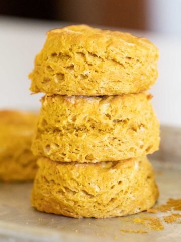 stack of pumpkin biscuits on baking sheet