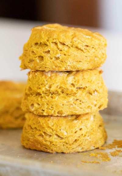 stack of pumpkin biscuits on baking sheet