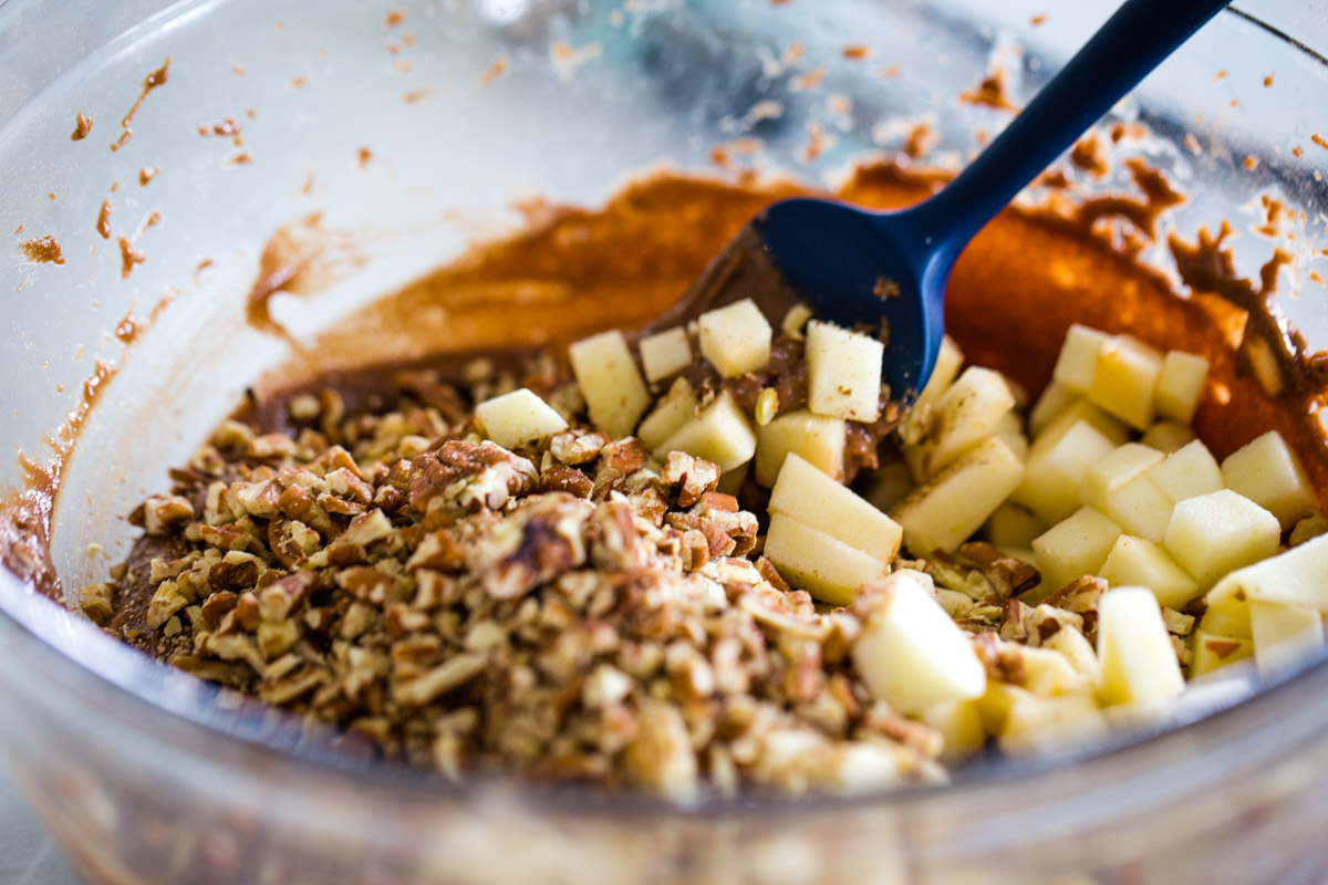 adding apples and nuts to batter