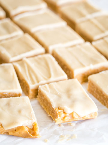 peanut butter bars sliced on parchment paper