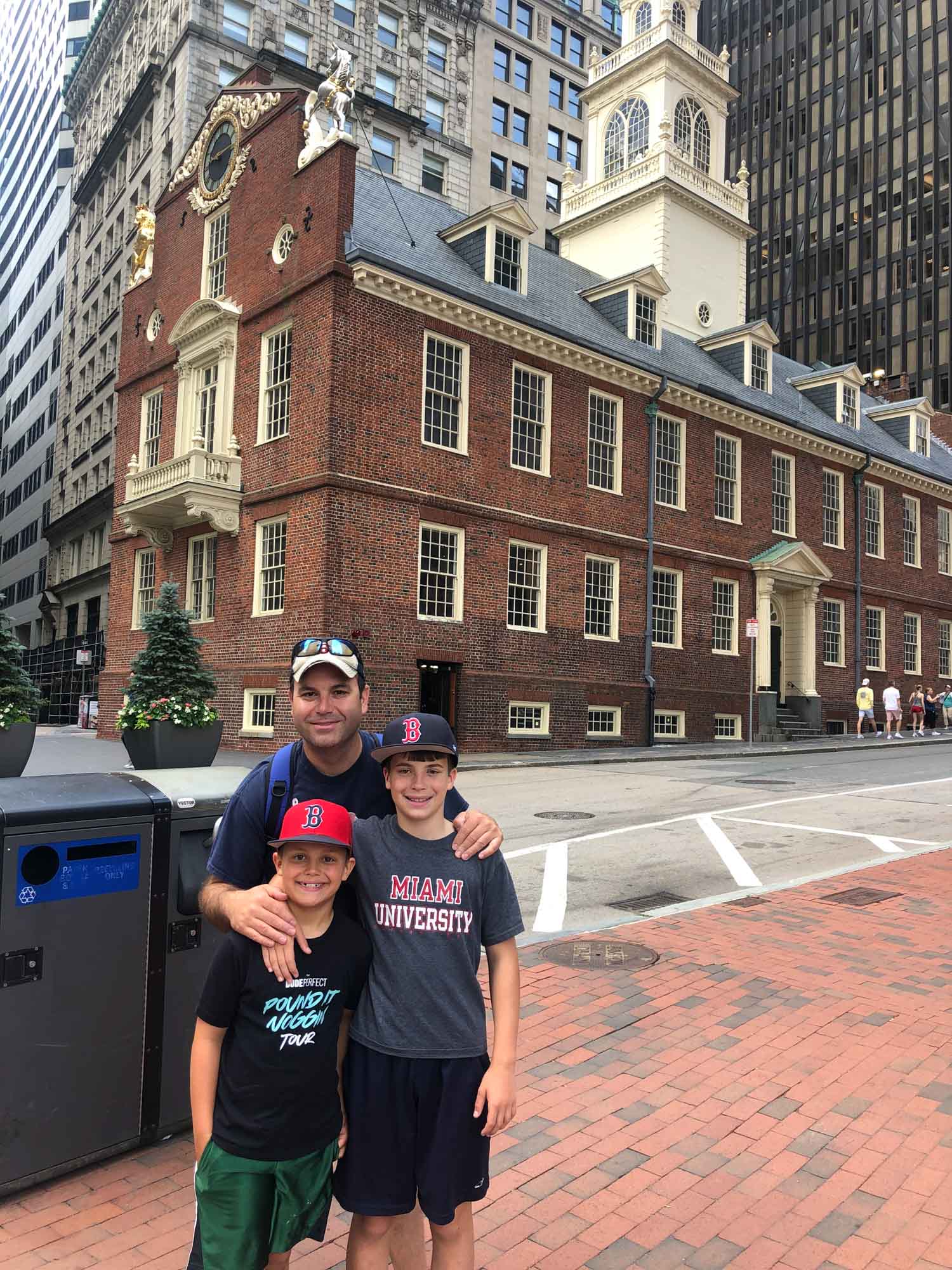 family in front of boston landmark