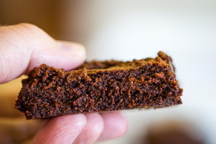 side view of brownie texture held by hand