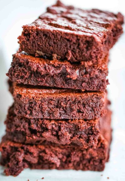 stack of red velvet brownies on parchment paper