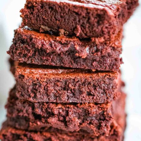stack of red velvet brownies on parchment paper