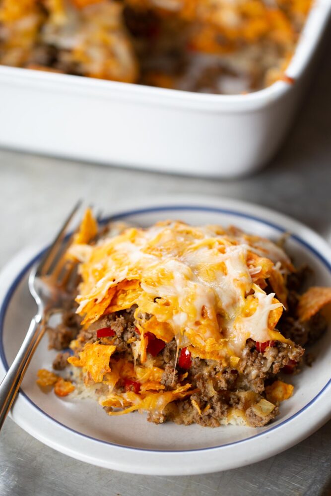 slice of taco casserole on plate with fork
