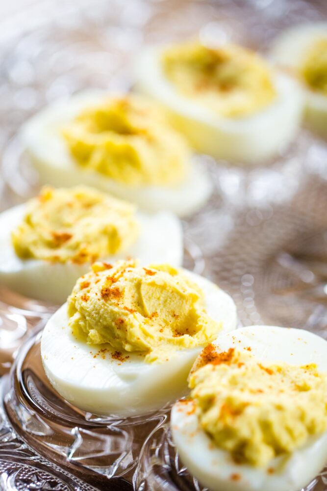 deviled eggs on glass antique serving dish