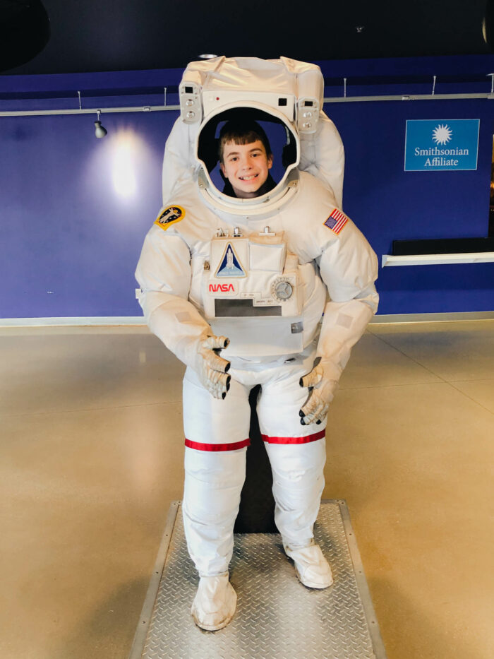 boy in space suit at space museum