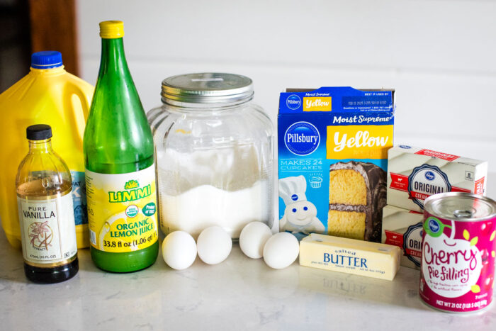 ingredients to make cherry cheesecake on kitchen counter