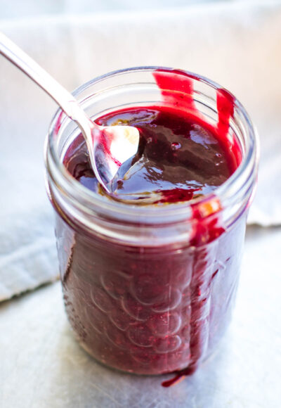 spoon full of blackberry sryup in jar