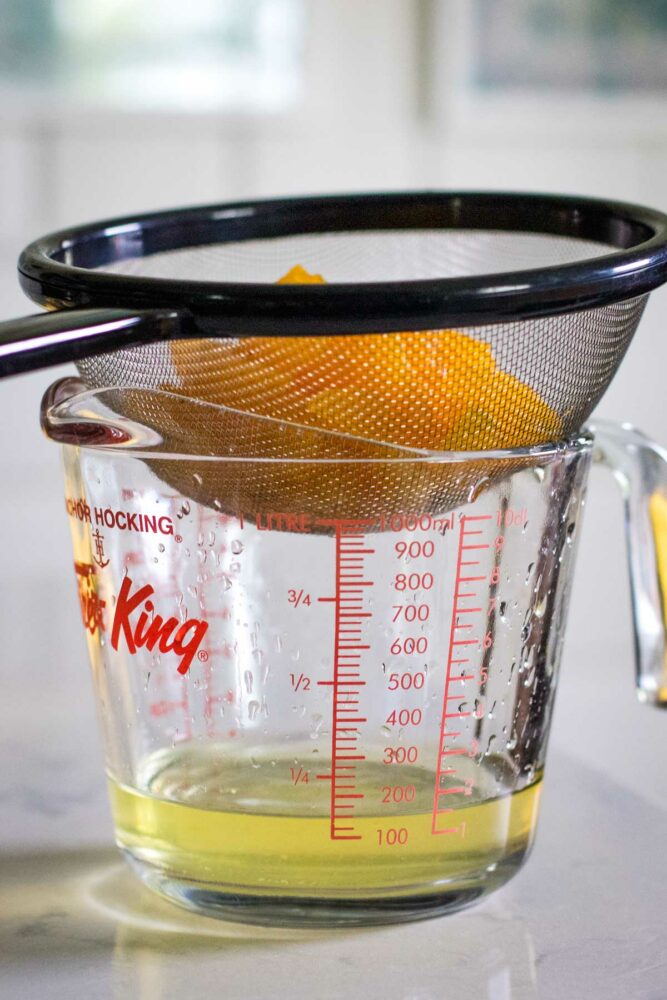 drained fruit in glass measuring cup
