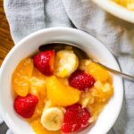 bowl of creamy fruit salad with spoon