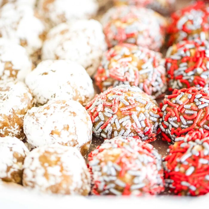 covered rum balls with powdered sugars and spinrkles