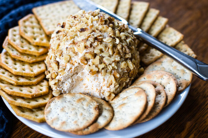 inside look of cheese ball with crackers and knife
