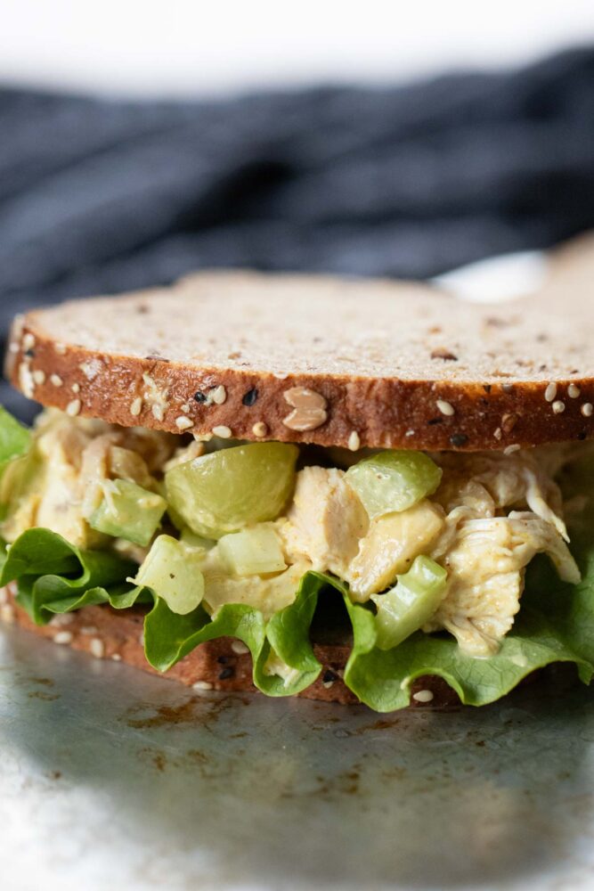 close up of inside sandwich filled with curry chicken salad