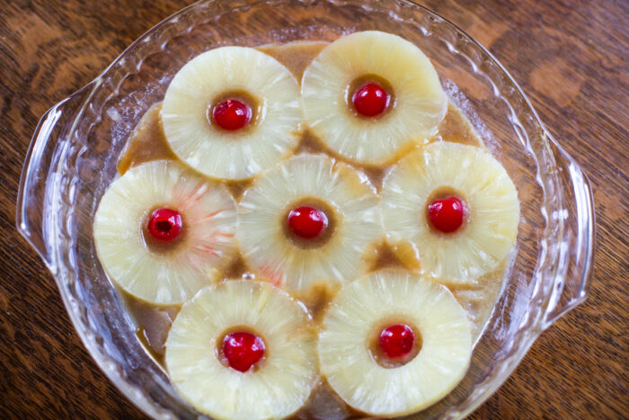 arranged pineapples and cherries in pie plate
