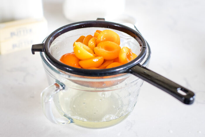 draining apricots into measuring cup