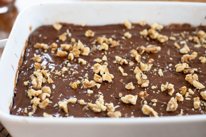 top chocolate cracker layer on date bars in baking dish