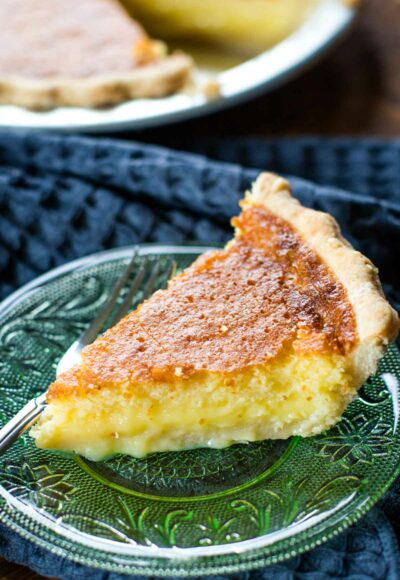 side view of slice of buttermilk pie on plate with fork