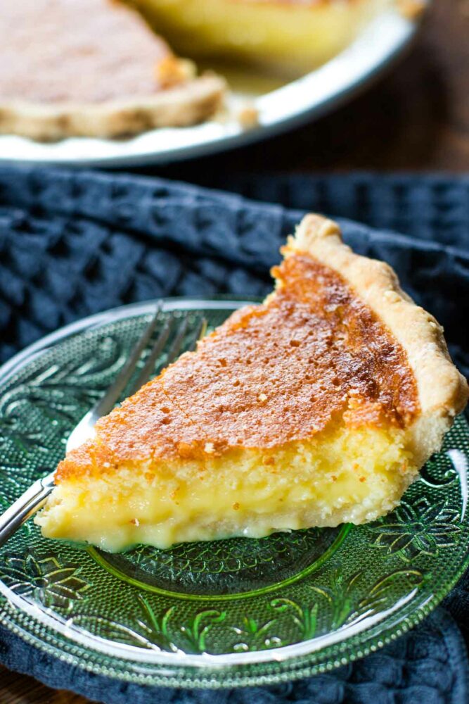 side view of slice of buttermilk pie on plate with fork