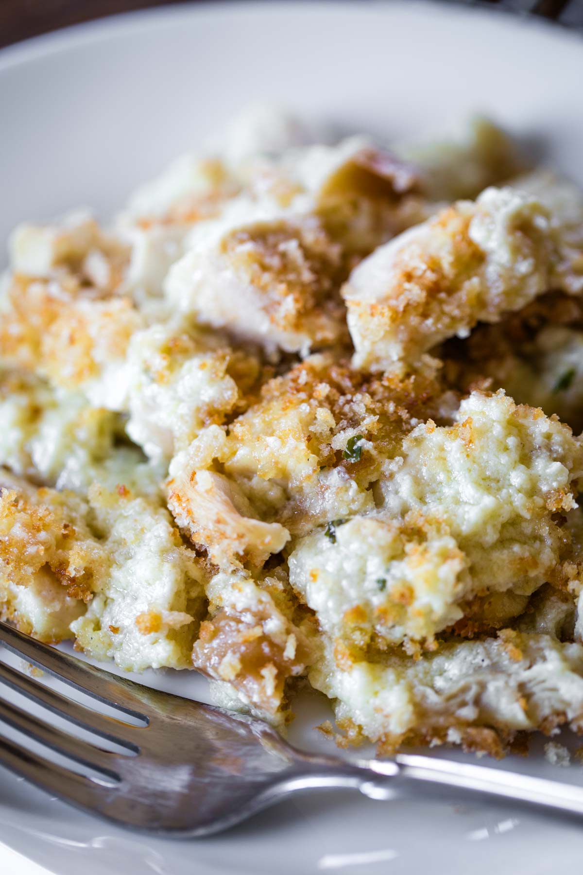 close up of bread pudding on plate with fork