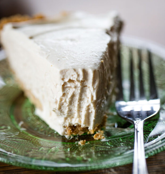 close up of fork taken bite out of peanut butter pie