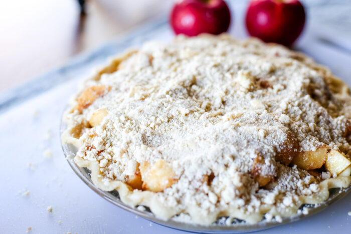 homemade dutch apple crumble topping on pie ready to bake