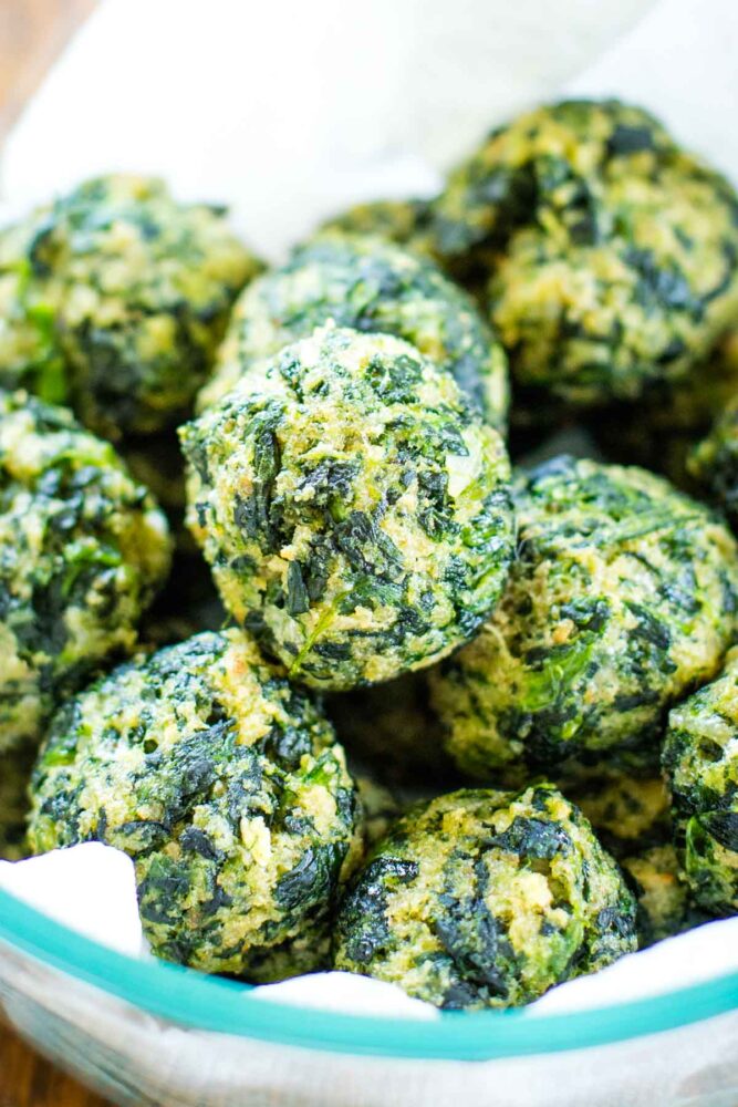 spinach balls stacked in large serving bowl
