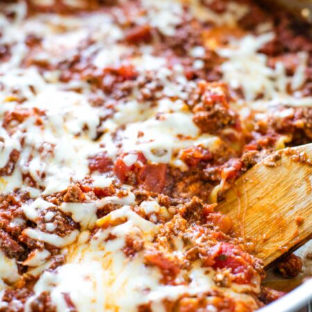 skillet lasagna baked and with spatula scooping out a slice