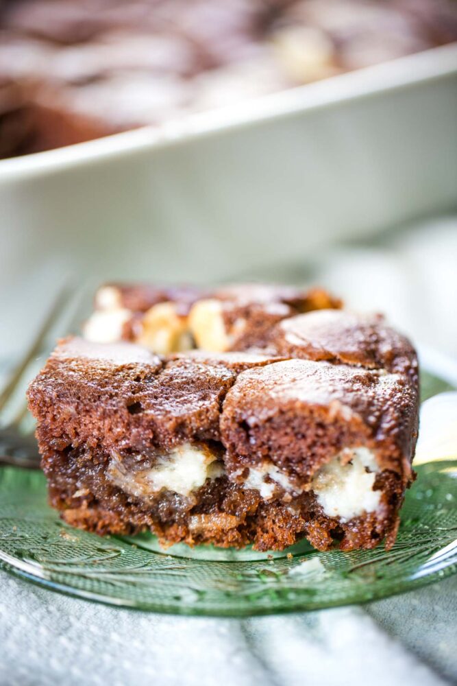slice of upside down german chocolate cake on green plate with fork