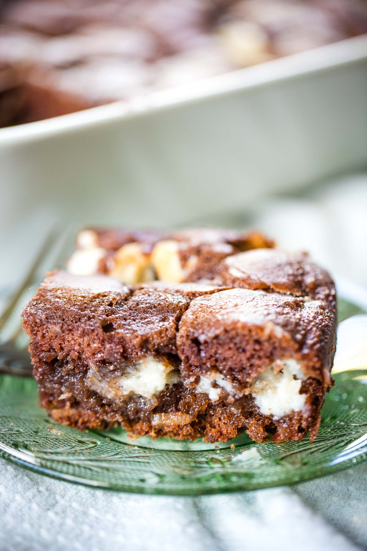 slice of upside down german chocolate cake on green plate with fork
