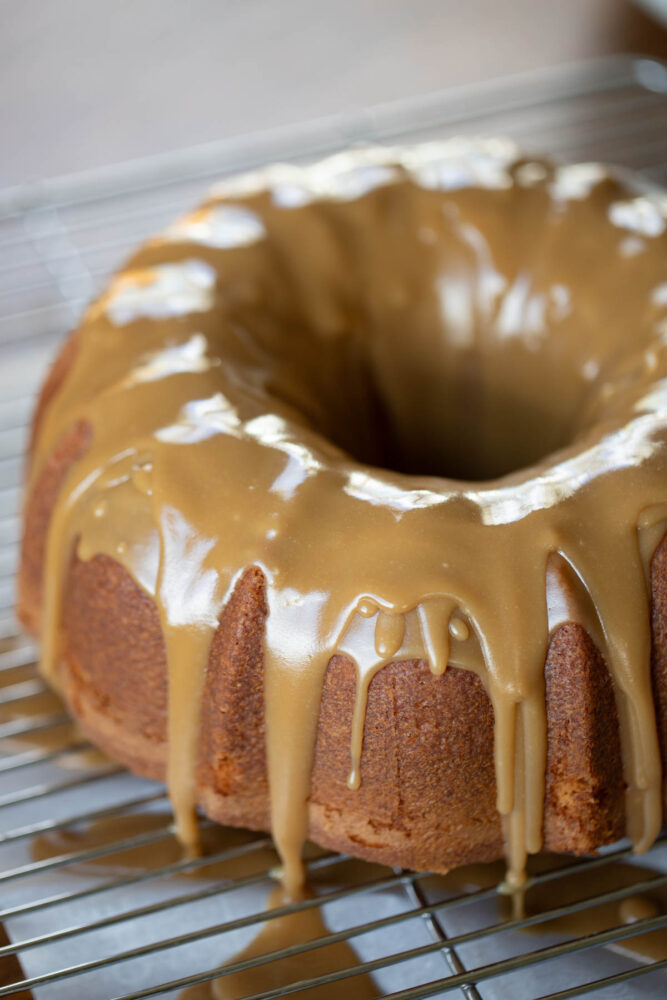 brown sugar glaze poured over a cake dripping onto table