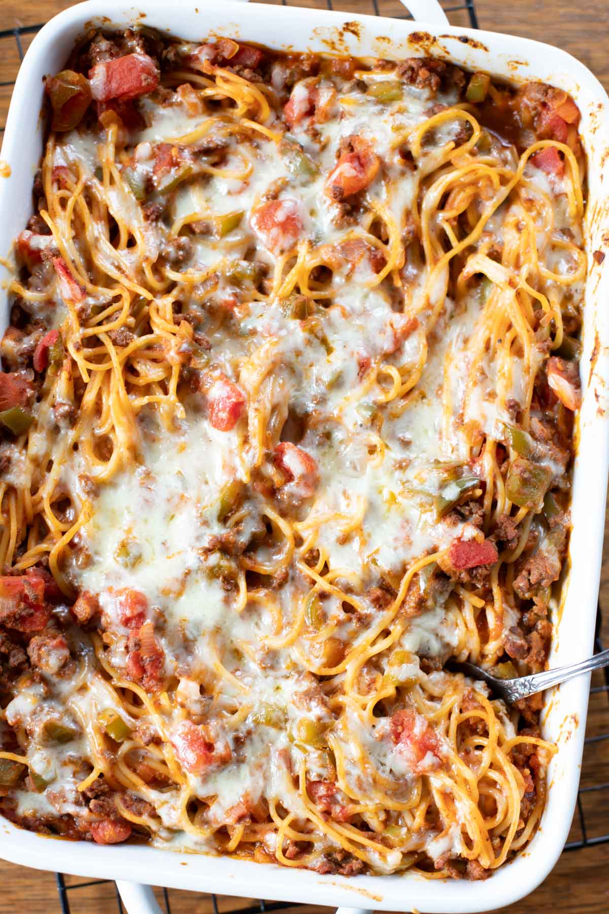 top view of baked spaghetti with spoon taking scoop out