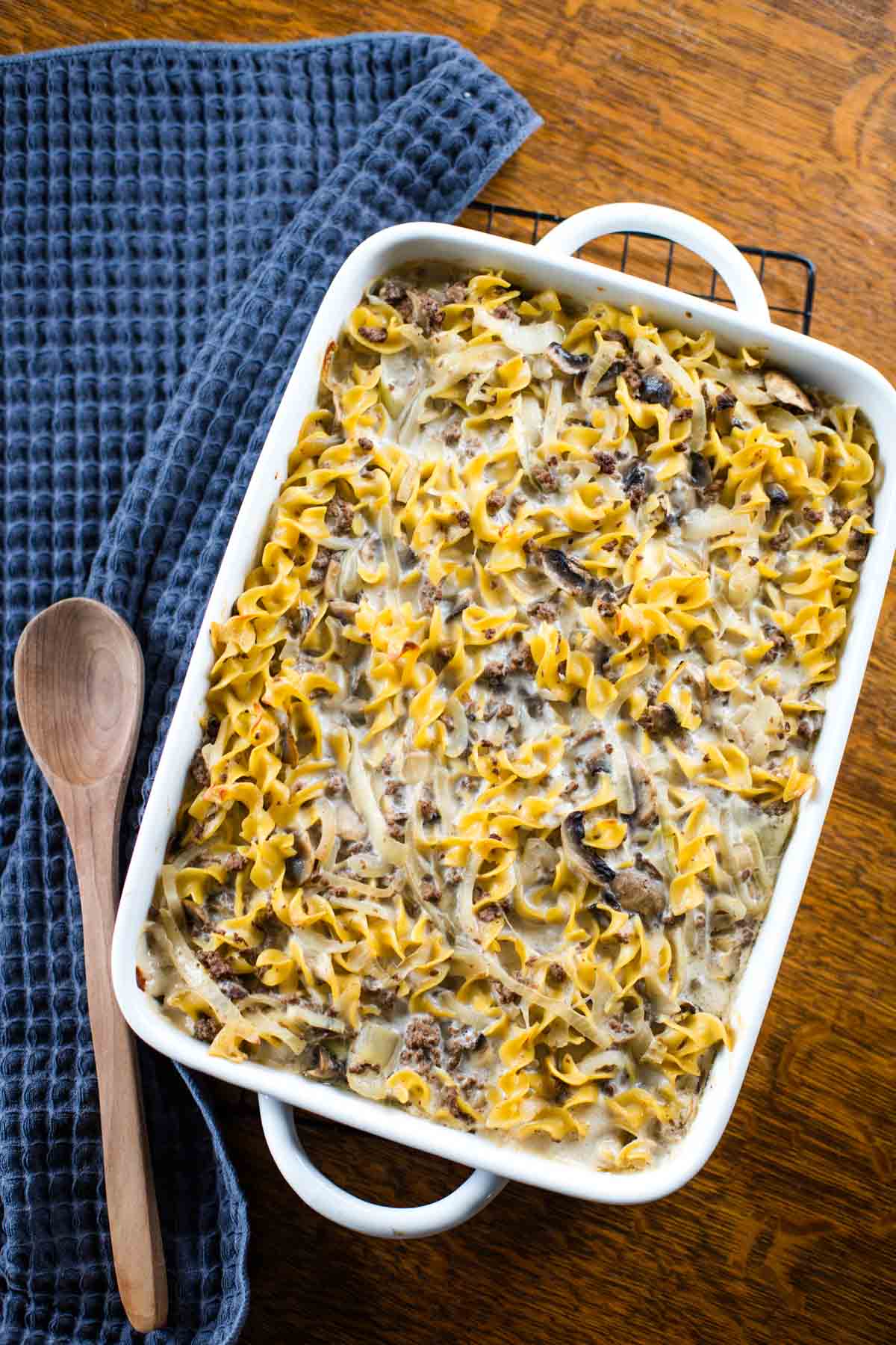 stroganoff casserole in baking pan with wooden spoon