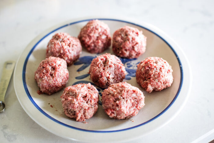 shaped uncooked meatballs on plate