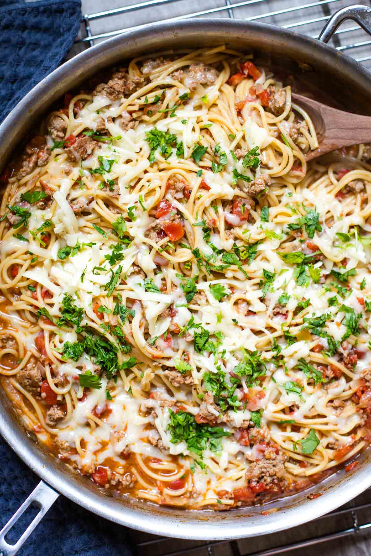 taco spaghetti in large skillet with wooden serving spoon